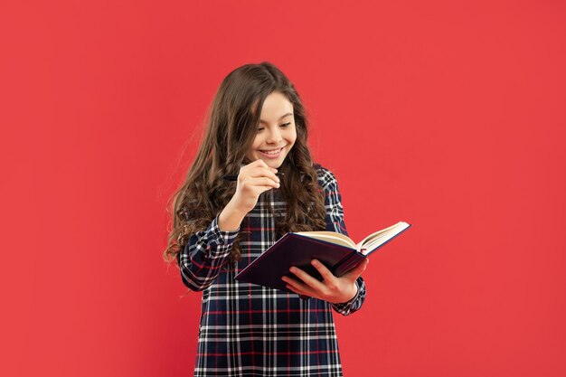 Concept of knowledge and wisdom. back to school. childhood education. smiling pupil or student hold notebook. teen girl study with book. child holding copybooks.