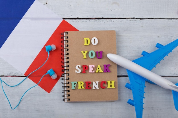 Concept of learning French language colorful letters with text Do you speak French flag of the France airplane