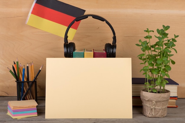 The concept of learning German language blank paper flag of the Germany books headphones pencils