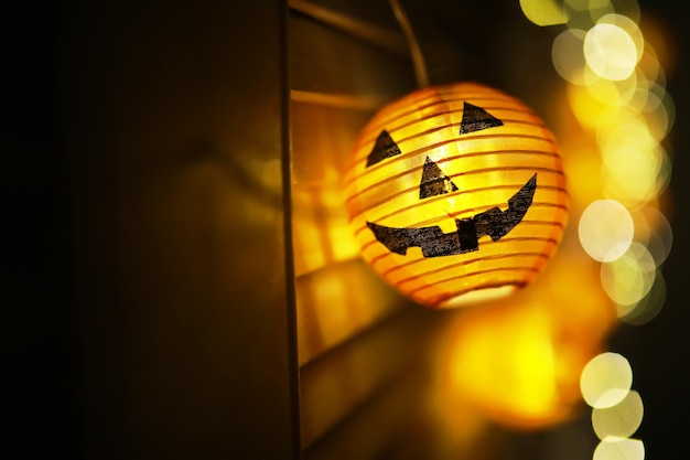 The concept of light on the night Halloween.Round lamp shape of pumpkin used to decorate with bokeh and copy space for text.