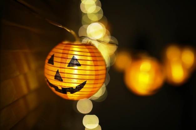 The concept of light on the night HalloweenRound lamp shape of pumpkin used to decorate with bokeh and copy space for text