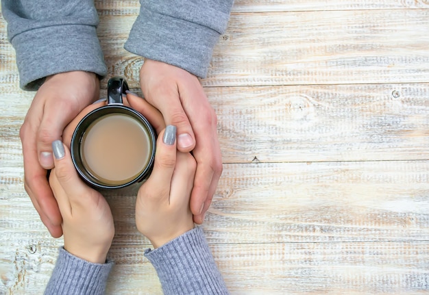 Concept of male and female hands, love and coffee