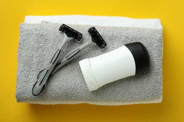 Concept of men's hygiene tools on yellow background