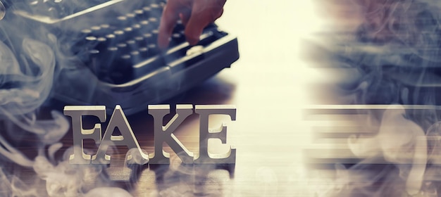 The concept of modern information technology Fake and facts in the news The letters spelled the word fake