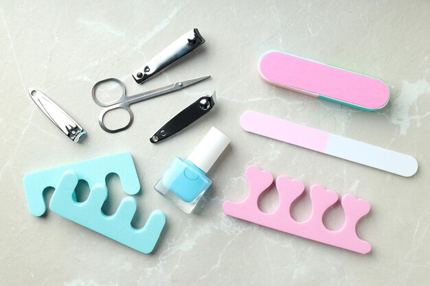 Concept of nail care with manicure accessories on light textured background