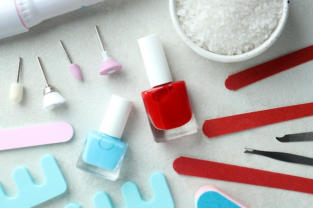 Concept of nail care with manicure accessories on light textured background