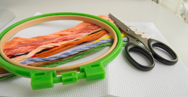 The concept of needlework. Sewing accessories for embroidery-canvas, Hoop, thread floss