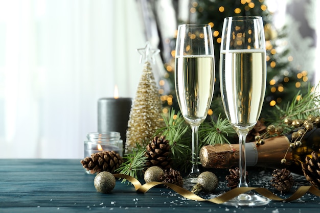 Concept of New Year celebration with champagne on wooden table.