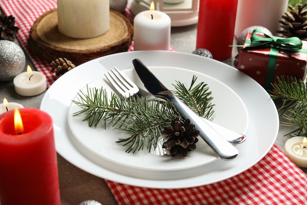 Concept of New year table setting with candles on gray table