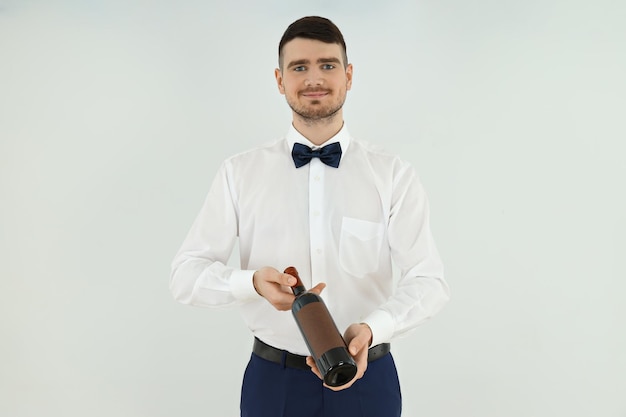 Concept of occupation young waiter on light background