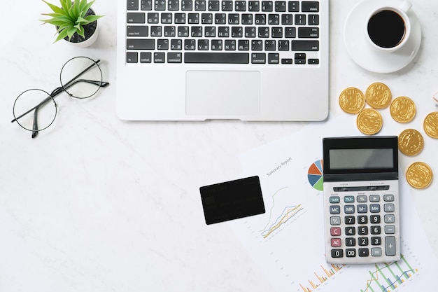 Concept of online payment with credit card with smart phone, laptop computer on office desk on clean bright marble table background, top view, flat lay