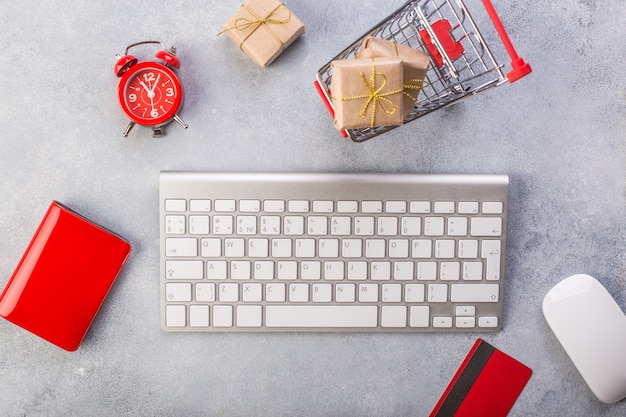 Concept online shopping buying presents. Red credit card, keyboard and mouse