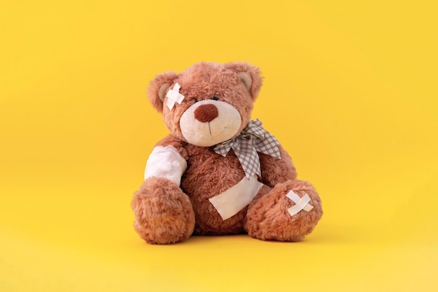 A concept of pain and illness problem, teddy bear toy wrapped in bandage, accident injury