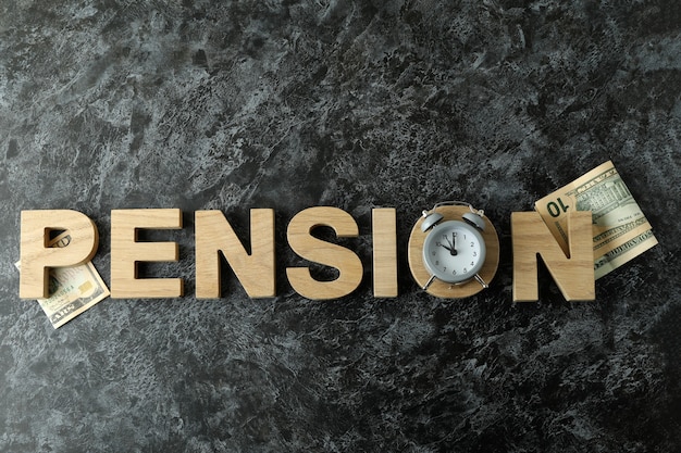 Concept of pension or retirement plan on black smokey table