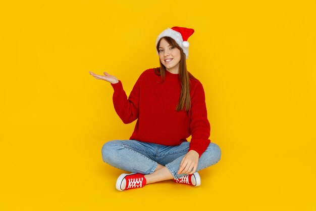 Concept of people girl in santa hat on yellow background