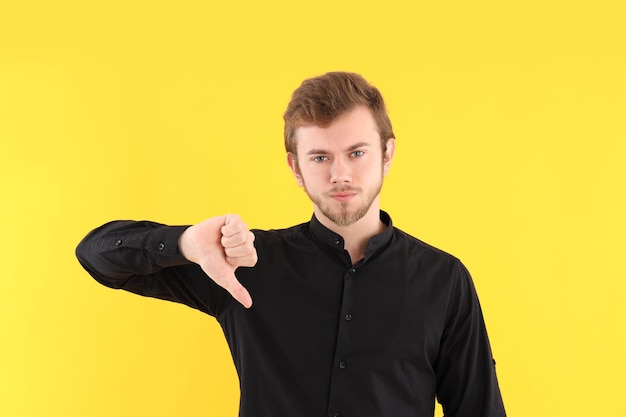 Concept of people with young man on yellow background