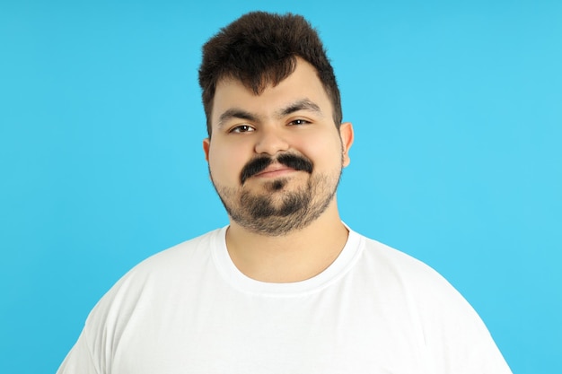 Concept of people young fat man on blue background