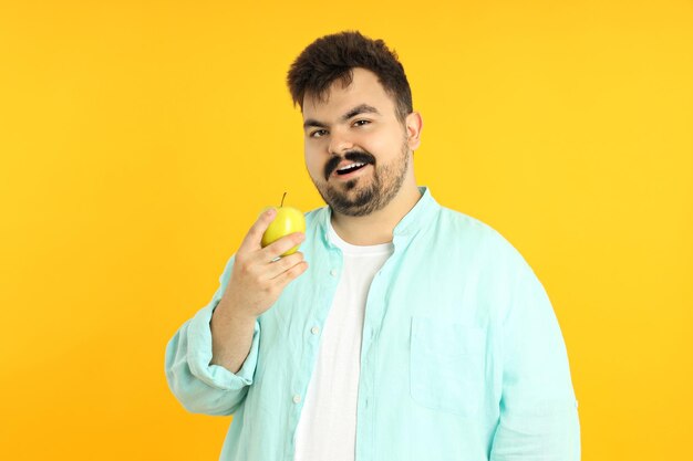 Concept of people young fat man on yellow background