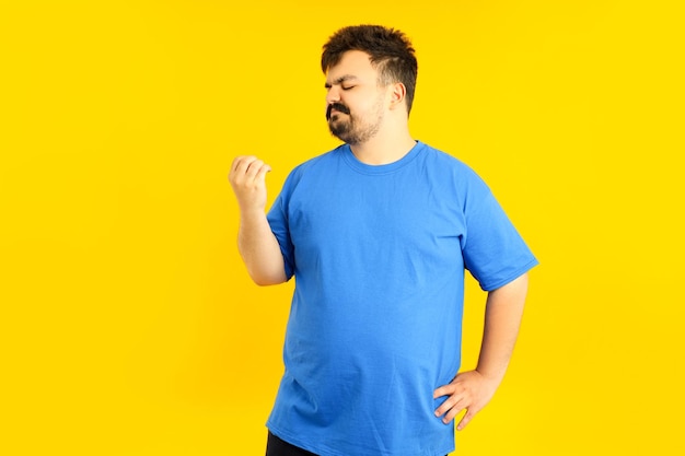 Concept of people young fat man on yellow background