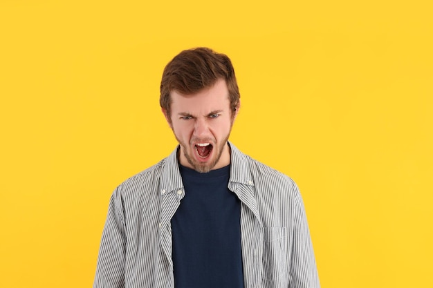 Concept of people young man on yellow background