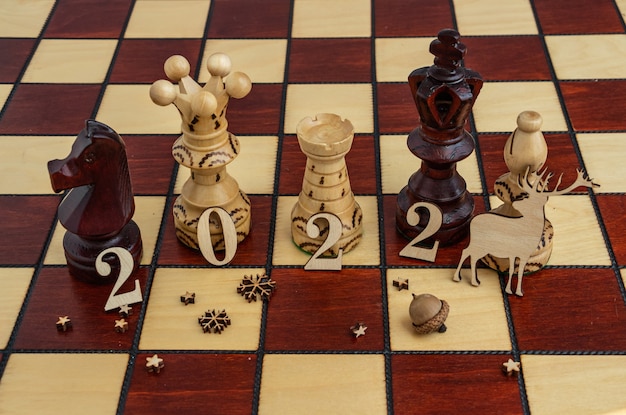 Concept photography new year composition on a chessboard flat lay copy space