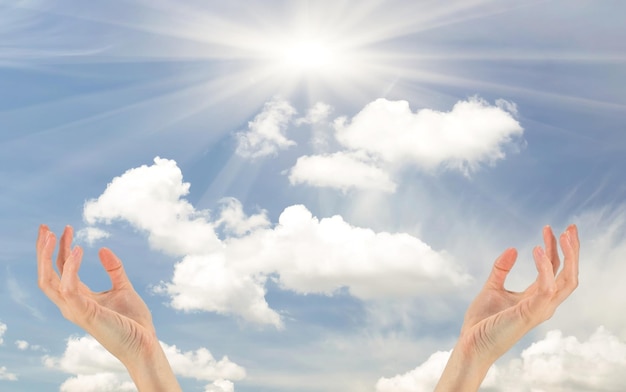 Photo concept of prayer and religion. two hands praying reach for the cloudy sky