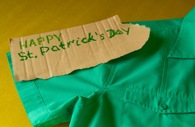 Concept of preparation for the celebration of St. Patrick's Day, green shirt lies on the table