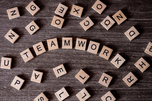 Concept presented by crossword with words teamwork with many wooden cubes