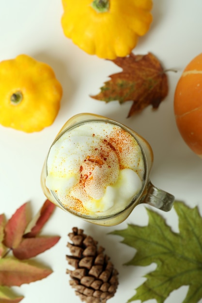 Concept of pumpkin latte on white table