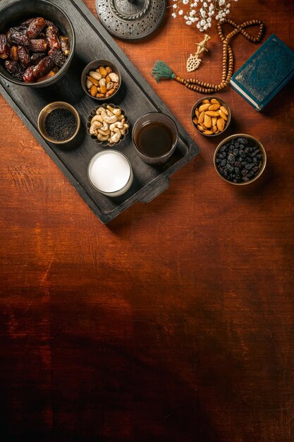 Concept of ramadan kareem food on dark wooden textured background