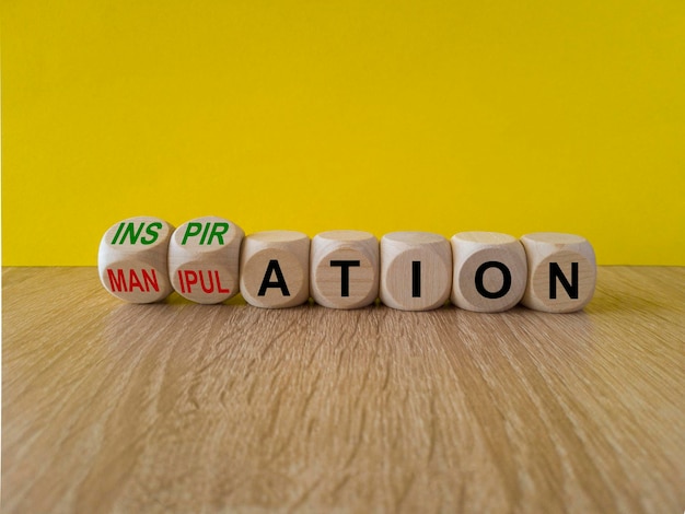 concept red words inspiration and manipulation on wooden cubes beautiful yellow background