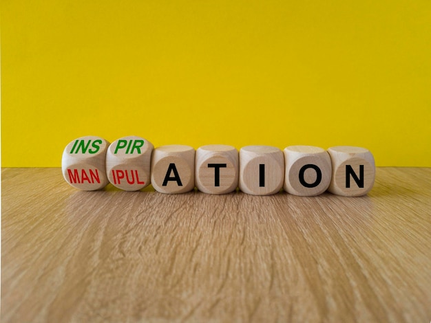 Concept red words Inspiration and Manipulation on wooden cubes Beautiful yellow background