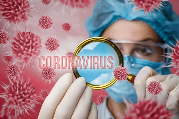 The concept of research and study of coronavirus Lab technician looks at viruses through a magnifying glass