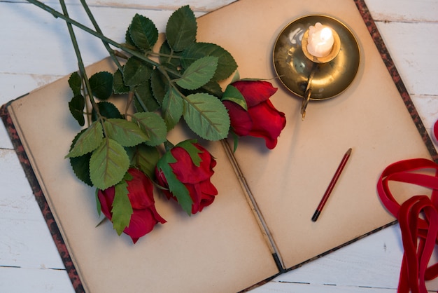 Concept romantic, old notebook,   roses and small candle