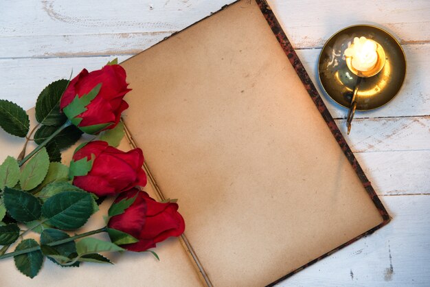 Concept romantic, old notebook,   roses and small candle