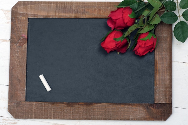 Concept romantic, small chalkboard and three roses