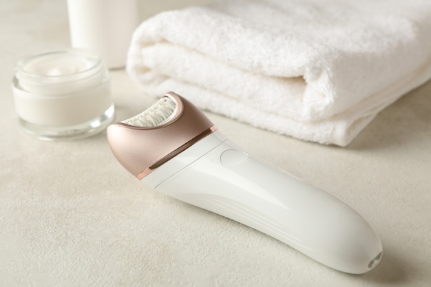 Concept of skincare with epilator on white table