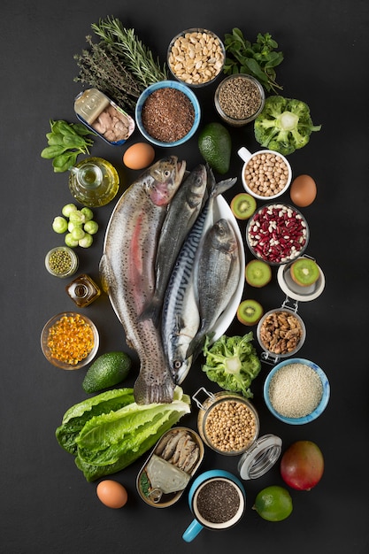 Concept Source OMEGA-3. Foods containing omega -3 sea fish, green vegetables, seeds, oil, fish oil.