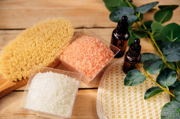 The concept of spa treatment Natural organic cosmetics with eucalyptus oil sea salt massage brush eucalyptus leaf extract Spa background Alternative medicine