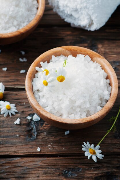 Concept of spa treatment with salt and daisy