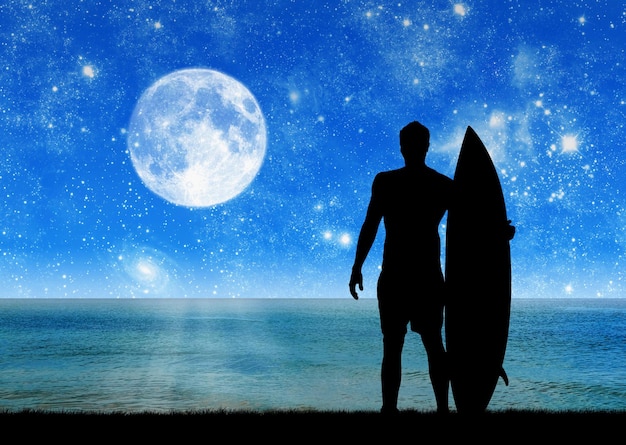 Concept of sport. Silhouette of surfer at night on the background of the sea