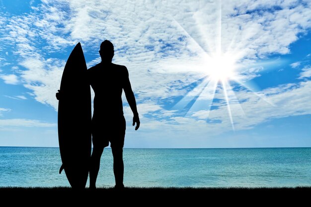 Concept of sport. Surfers silhouette against the sea in the morning