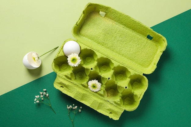 Concept of spring eggs with flowers top view