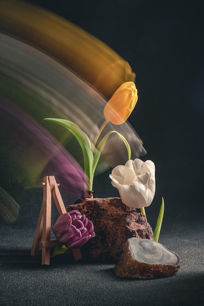 Concept spring freakebana three multicolored tulips motion blur
