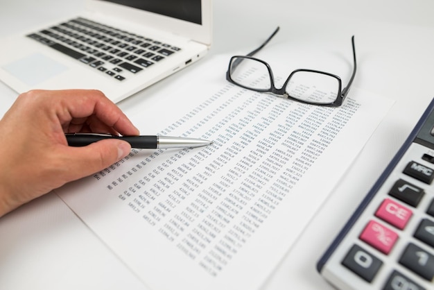 the concept of statistics financial analysis business economics business woman's hand points to the numbers