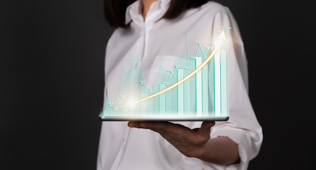 Concept stock market exchanges. woman hand holding digital tablet and showing financial graph.