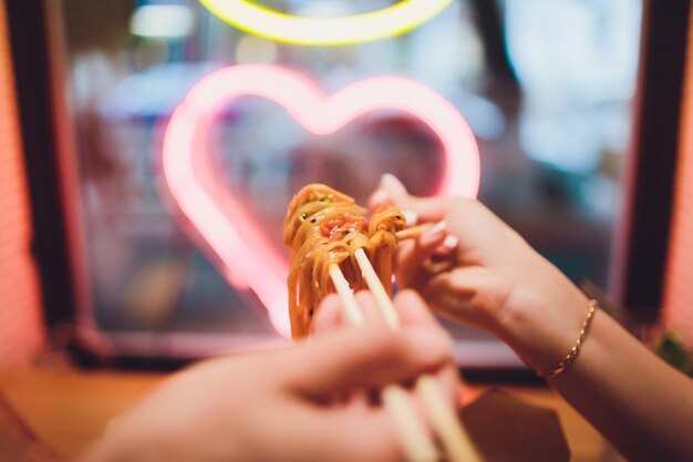 concept of street food chinese japanese noodles with chicken and vegetables in disposable paper