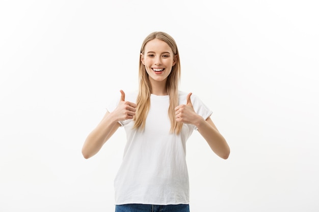 Concept of success happy student. Portrait of attractive smile teenage girl show thumbs up gesture, in white shirt, isolated over white background.