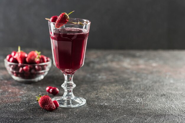 The concept of a summer refreshing drink from red berries: berry Morse of fresh strawberries and cranberries