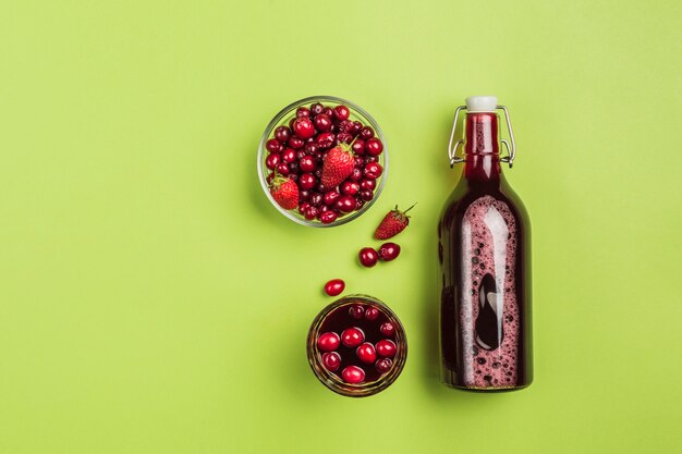 The concept of a summer refreshing drink from red berries: berry Morse of fresh strawberries and cranberries